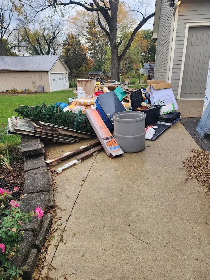 Dumpster being loaded with debris for Estate Cleanout Dumpster Rental in Ocean Pines